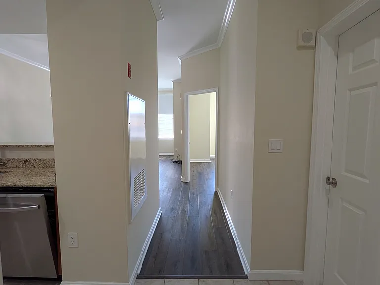 Main entry with kitchen to the left and bathroom to the right