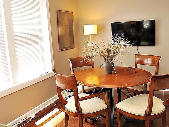 Sunny living room with modern light fixture.