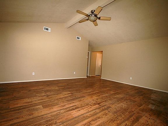 Family Room has recent lighting and laminate wood floors wit