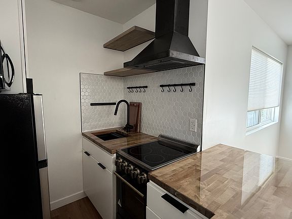 Compact Kitchen with Butcher Block Countertops + Breakfast Counter