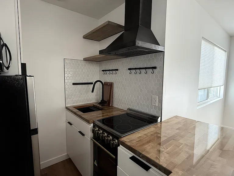 Compact Kitchen with Butcher Block Countertops + Breakfast Counter