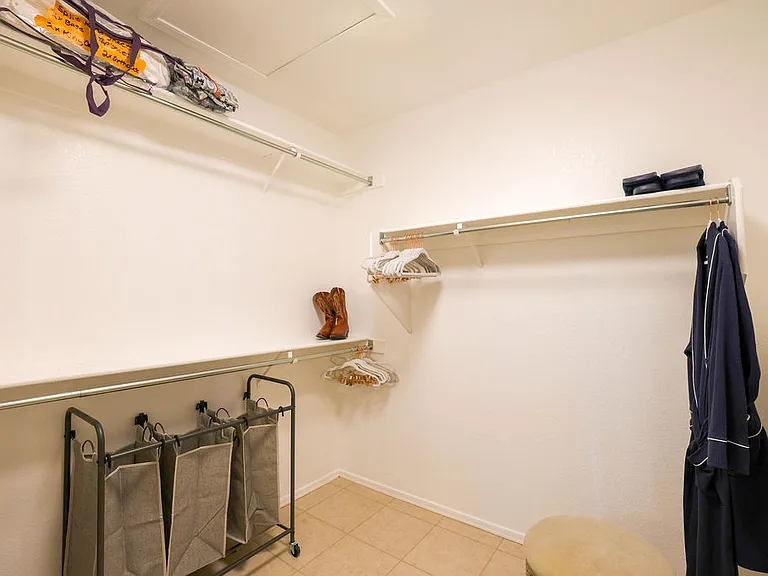 Master suite walk in closet with robes and slippers