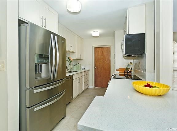 Ceramic tile floor in the kitchen; door leads to your private one-car garage with auto garage door and an extra refrigerator for those Costco runs or party foods and soda. New cabinetry and hardware.