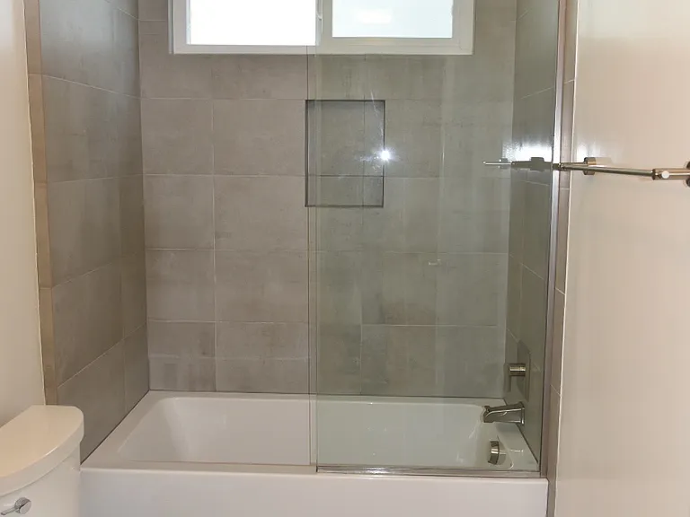 Large soaking tub/shower with frameless glass enclosure