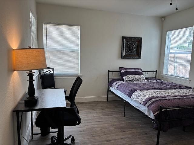 Room 2 with Queen Bed. Workspace, and clothes hanging system