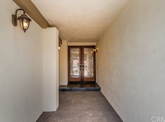 Stamped concrete leads to double door entry