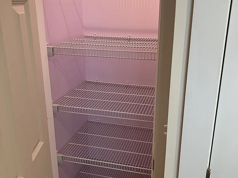 Small closet next to washer and dryer in entry hallway