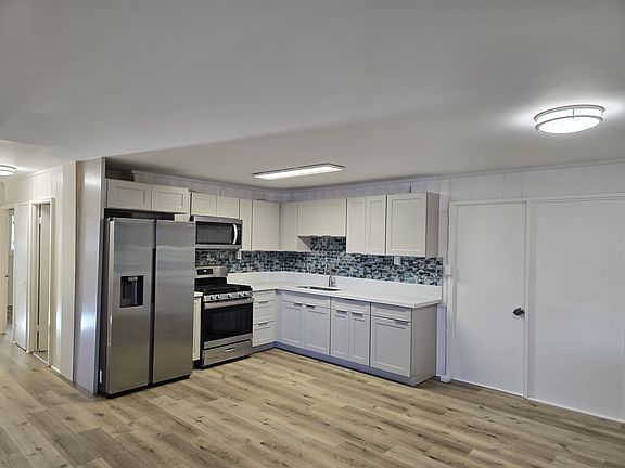 Kitchen and hallway to bedrooms on left
