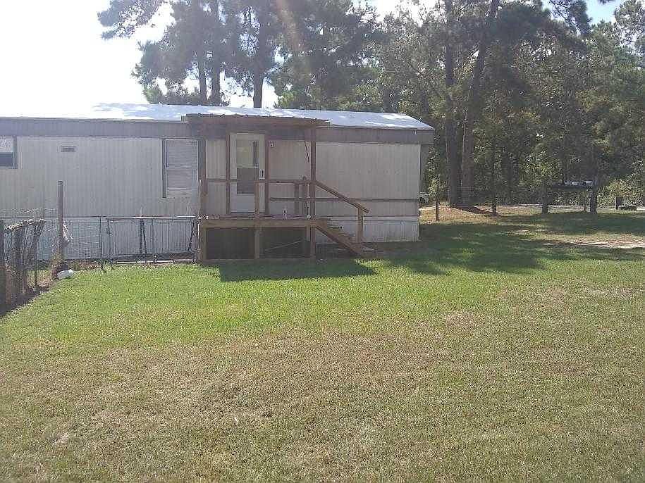 Northern View of the trailer and porch. To the left is the gate to the back yard.