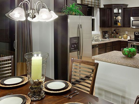 The dining area is conveniently located off the kitchen, with a peninsula that could be used as a se