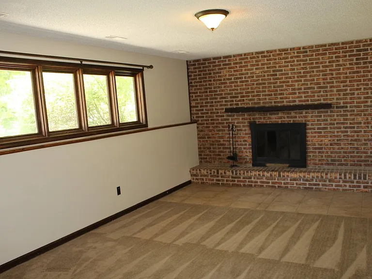 Downstairs Family Room with wood burning fireplace. For nice cozy Kansas winters