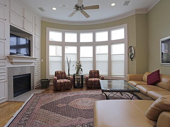 Living Area: high ceilings, wall of windows, fireplace, custom built in shelves