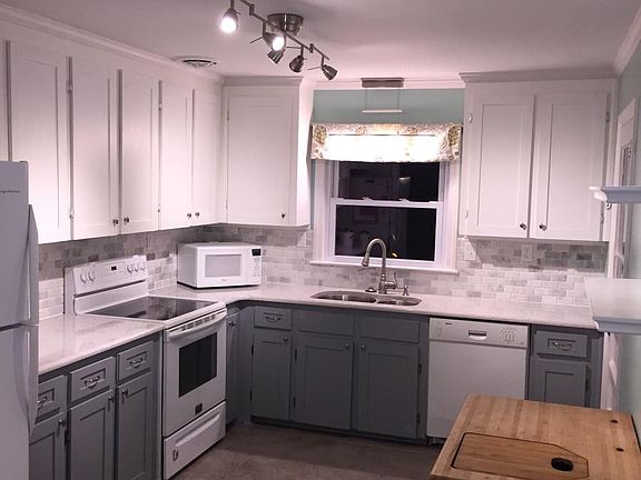 Kitchen with Quartz countertops and Stone Backsplash