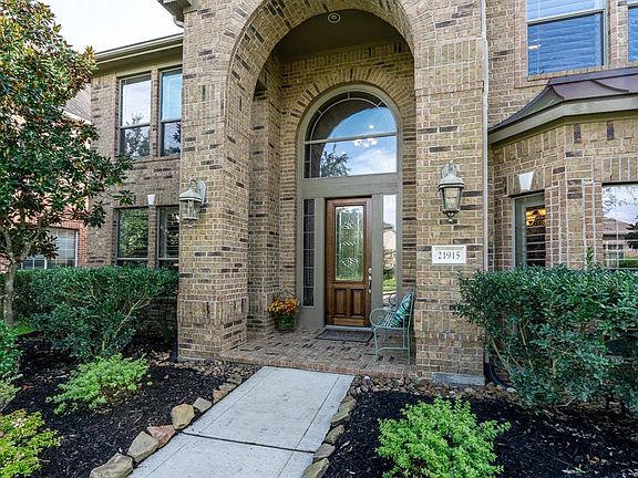 Charming landscape beckons you to gather under the front porch arch or take a seat and visit with neighbors!
