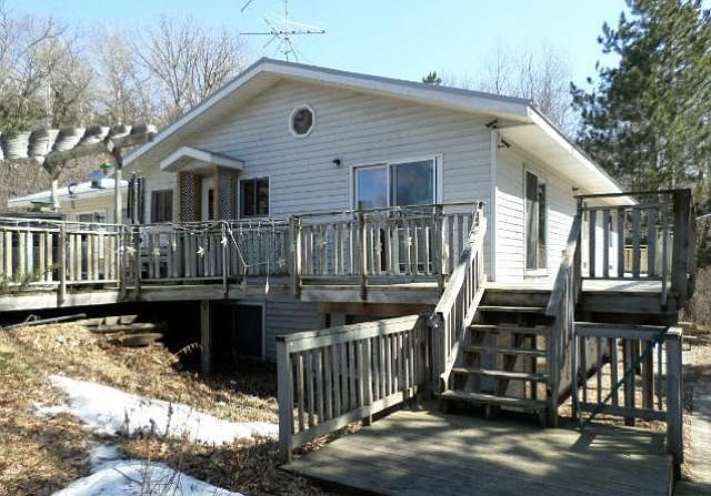 View of front of home with large wrap around deck!