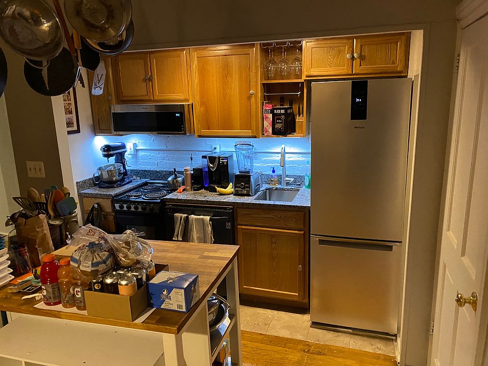 Kitchen area in central room. Stone counter, dishwasher, kitchen island.