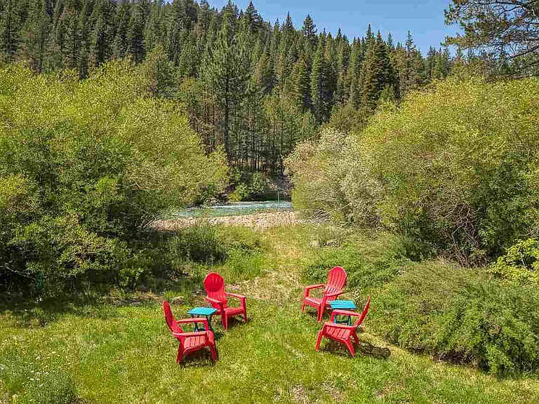 Large riverfront lawn ideal for relaxing, entertaining, or summer afternoons outdoors