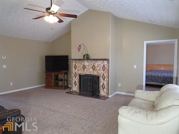Great room with vaulted ceiling and fireplace