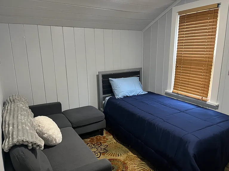 Additional sitting room. Sofa, twin bed and television