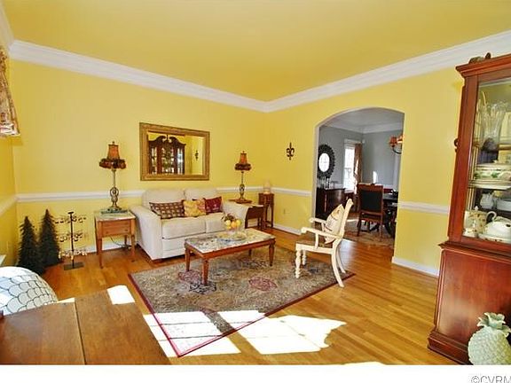Large living room with hardwood flooring, chair molding and trip