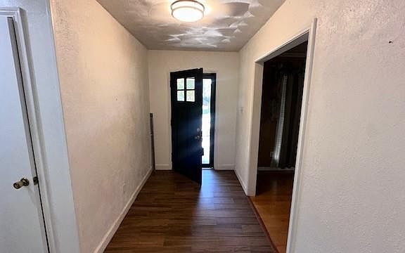 Entryway with dark hardwood / wood-style flooring