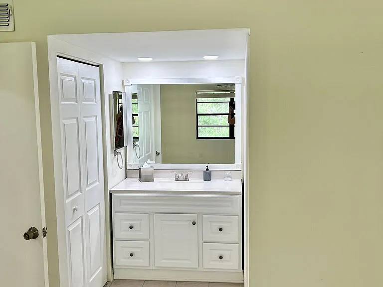 En Suite bathroom in primary bedroom with extra closet to the left.
