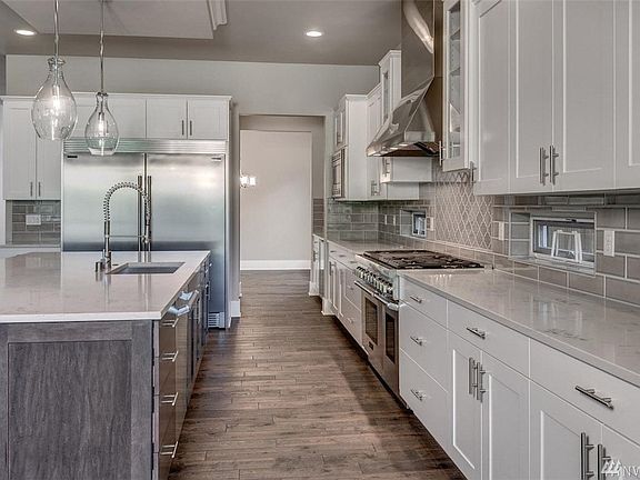Photos are of a similar plan; details will vary due to builder and buyer options. All of Foxwoods' homes will include 48" Thermador Pro-Series Range and Hoods, side-by-side refrigerator/freezer, stacked cabinets w/crown extending up to the 10' ceiling, 5 stain-options for cabinets as well as painted upgrade options....