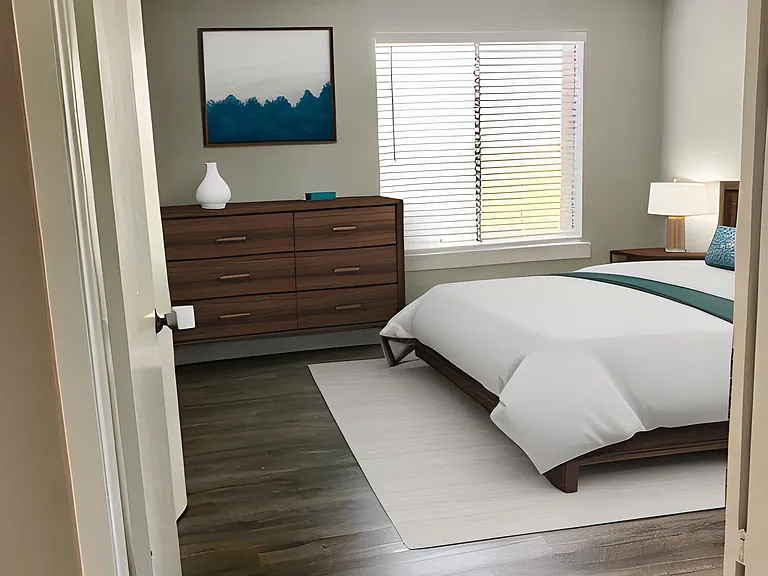 Large bedroom with double doors open to living space.