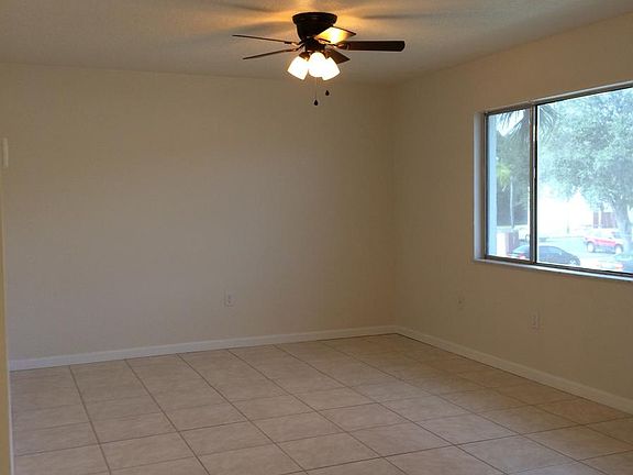 Main living area with large, open window, new fan/ light fix