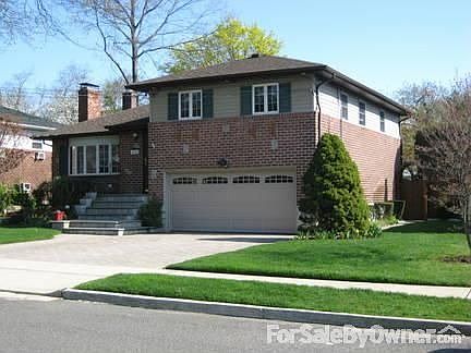 Brick Split w/ 2-car grg; paved drwy; Andersen wdws; OVERSIZED yard- a MUST SEE!