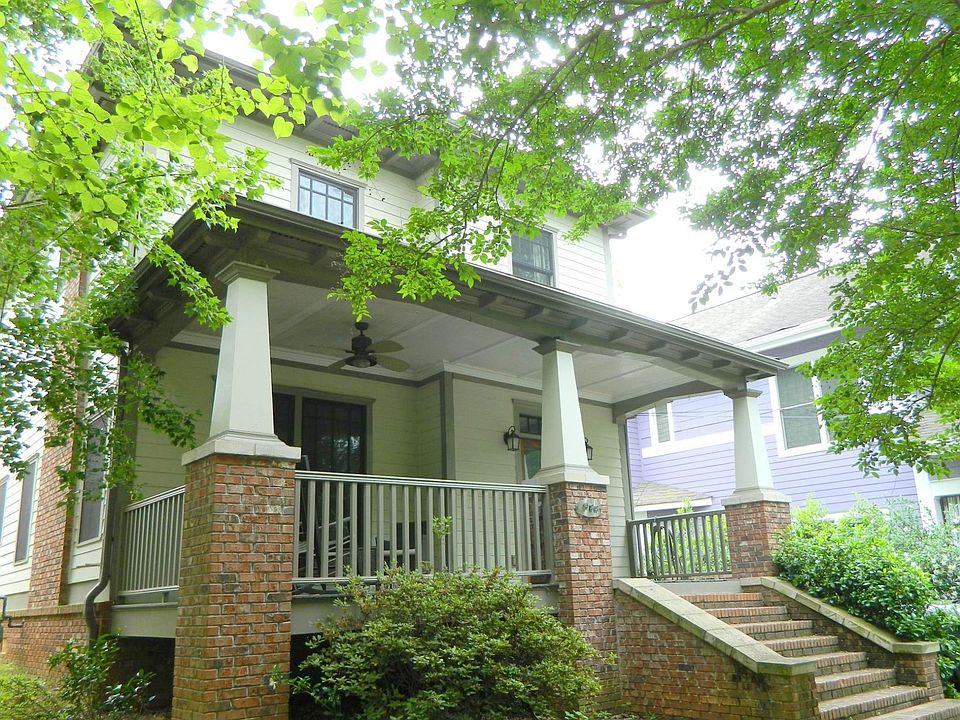 Front of house with beautiful shade trees and large front porch for evening gatherings and cocktails with the neighbors