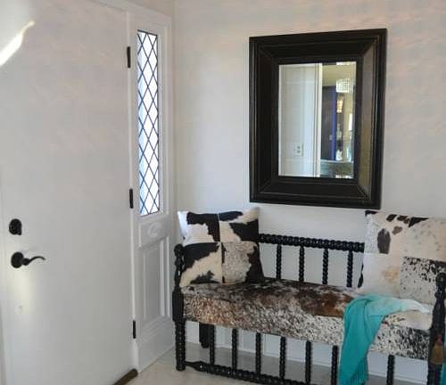 The front entrance is grand!  It features marble flooring and a very unique light fixture.  The crown molding starts the minute you walk in and follow through the entire home.