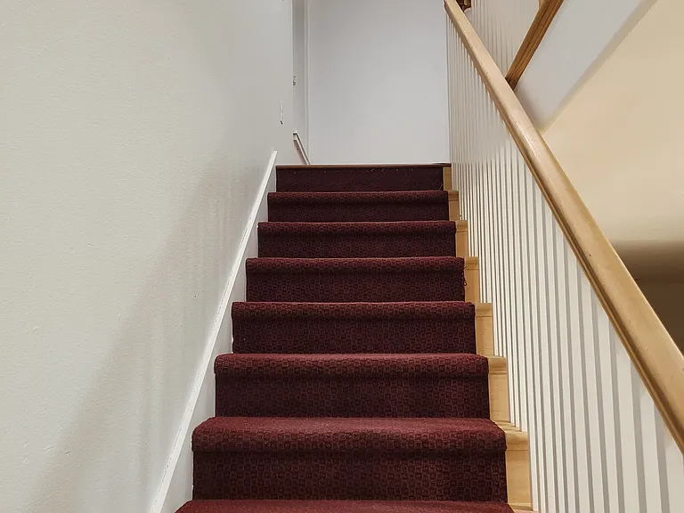 stairway leading to second story bedrooms, bath and laundry