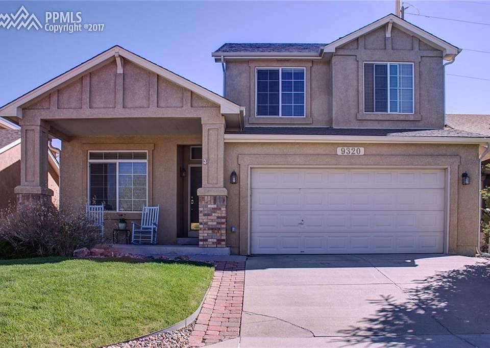 Welcoming covered front porch. Stucco exterior.