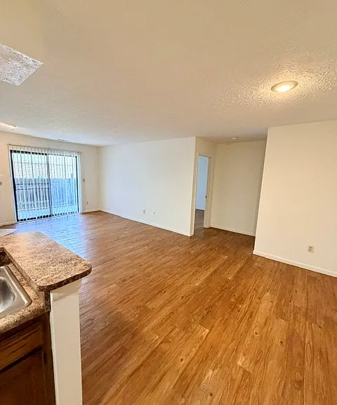 View of the living room from the kitchen- sliding glass doors to patio.
Second bedroom and bathroom on the right doorway