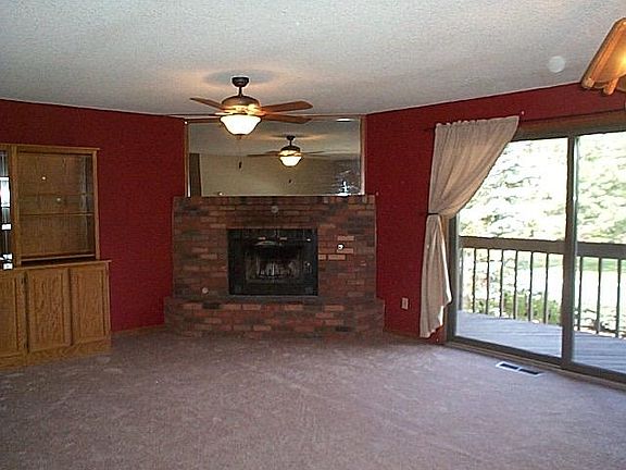 Living Room w/Fireplace & built in buffet and lots of mirrors.