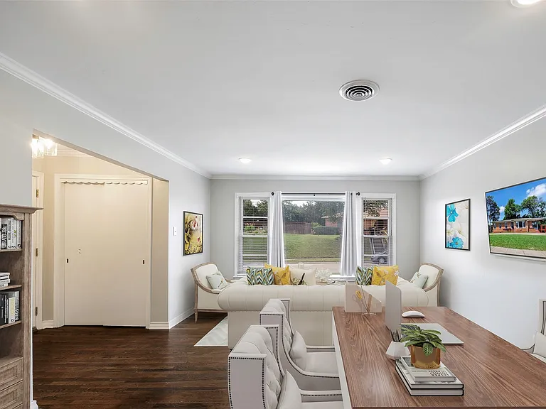 Virtually staged Recreation room with ornamental molding and dark wood-type flooring