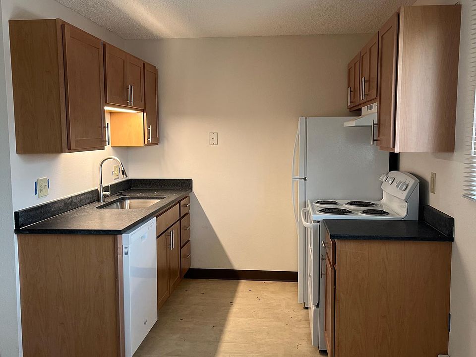 Updated kitchen with granite countertops, dishwasher, custom cabinets.