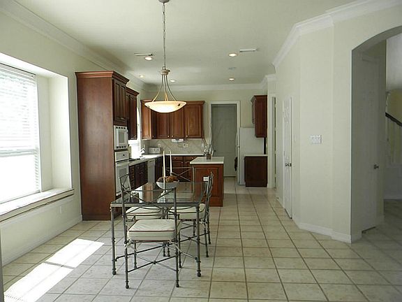 THE KITCHEN OFFERS A LOT OF NATURAL LIGHT, AN ISLAND, 42-IN CABINETS, & ALSO HAS A BREAKFAST AREA.
