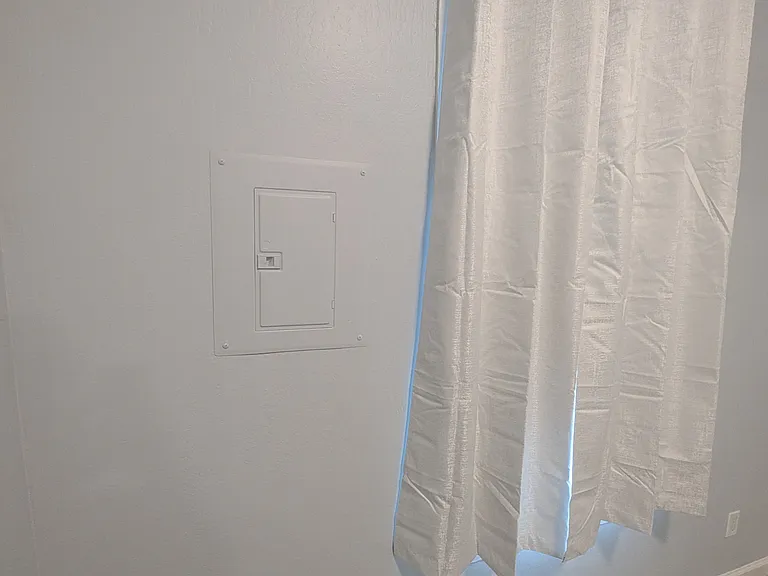 New front window and new curtains. Electrical sub-panel.
