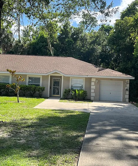Front of House with long driveway.