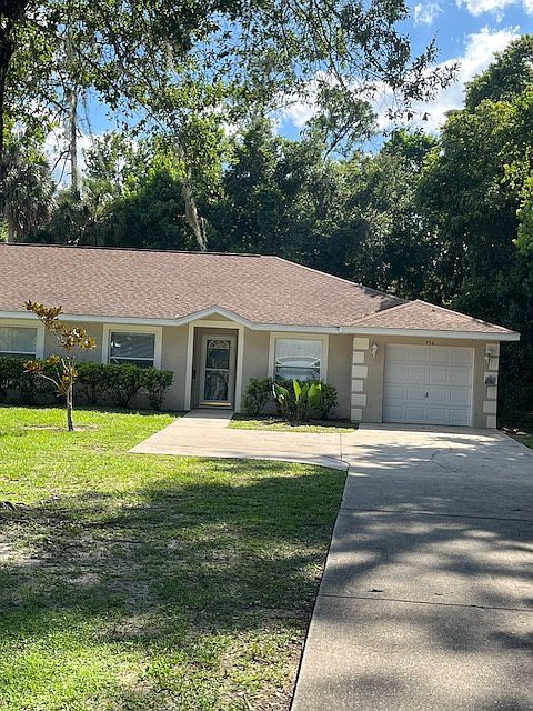 Front of House with long driveway.