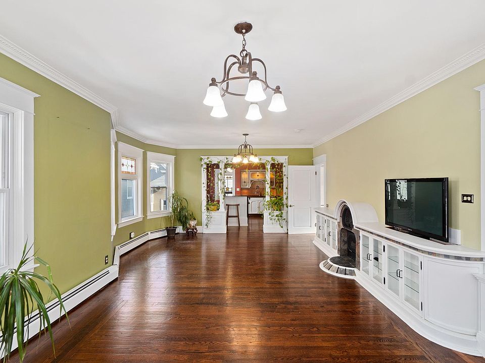 Living room. There is ample space for a dining table by the bay window.