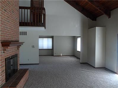 spacious great room with all new carpet through out the house.