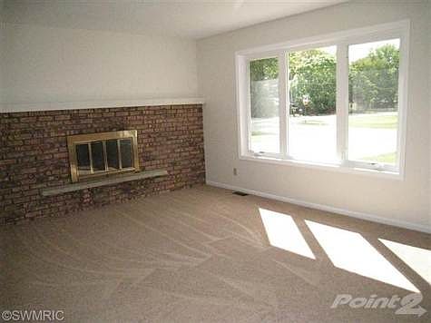 Living room w/ wood burning fireplace