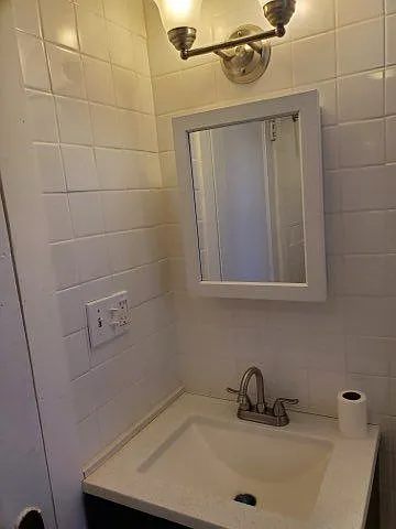 Newly tiled bathroom and new sink and mirror