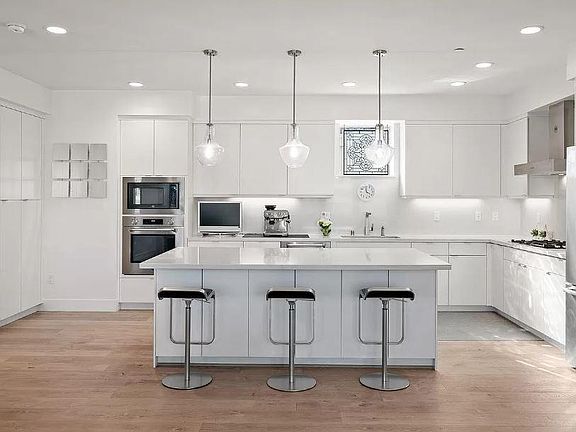 Spacious kitchen with ample storage, gas stove.