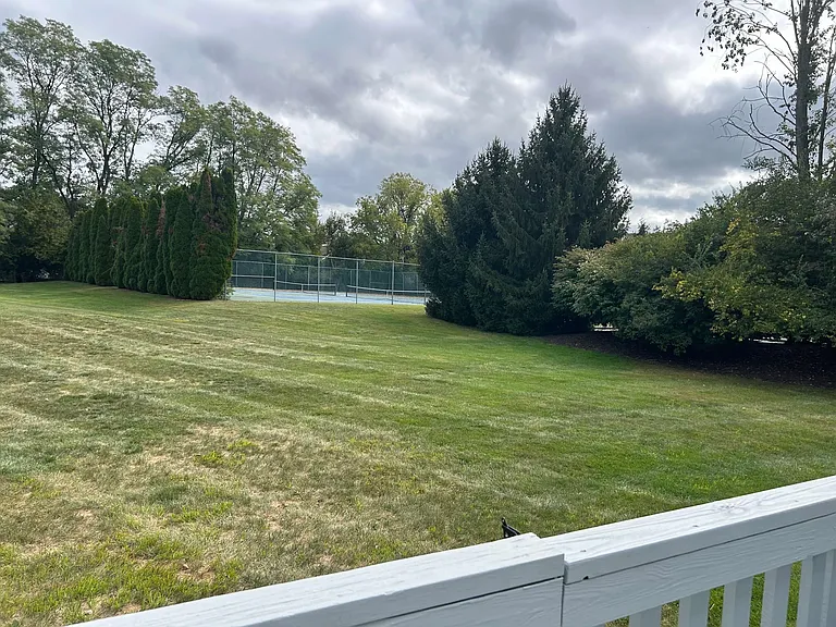 Big common area like a backyard in back with view of community tennis courts and a walk away from pool and kids playground