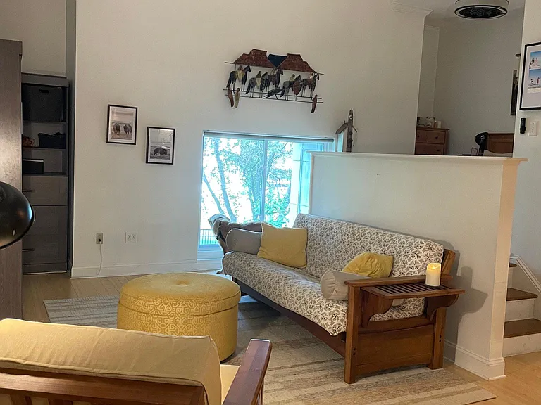 Light filled room with oversized window and high ceilings.