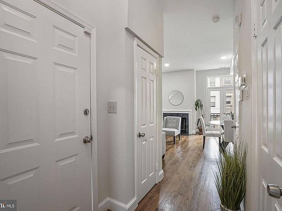 Entrance with coat closet on one side and pantry and powder room on the other.